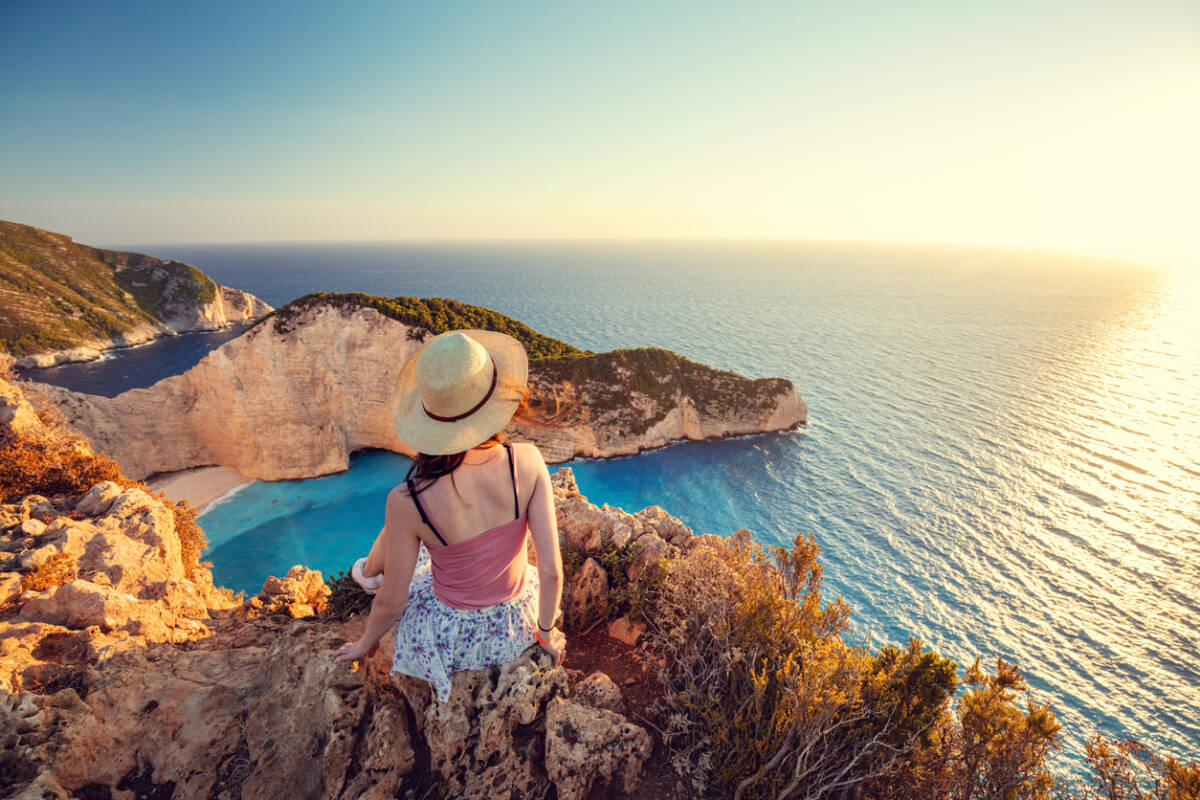 woman looking out over the coast in Greece.