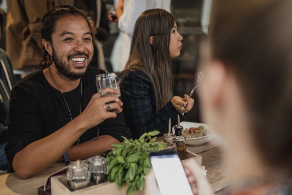 Friends socialising in a restaurant/ bar with drinks.