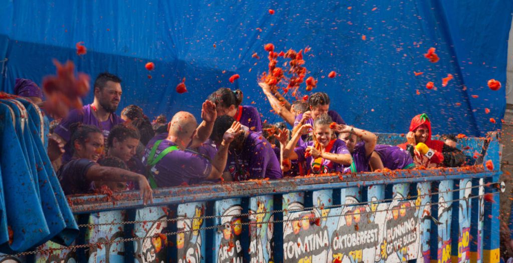 BUNOL, SPAIN - AUGUST 30, 2018: People during La Tomatina festival. La Tomatina festival where people are fighting with tomatoes at street