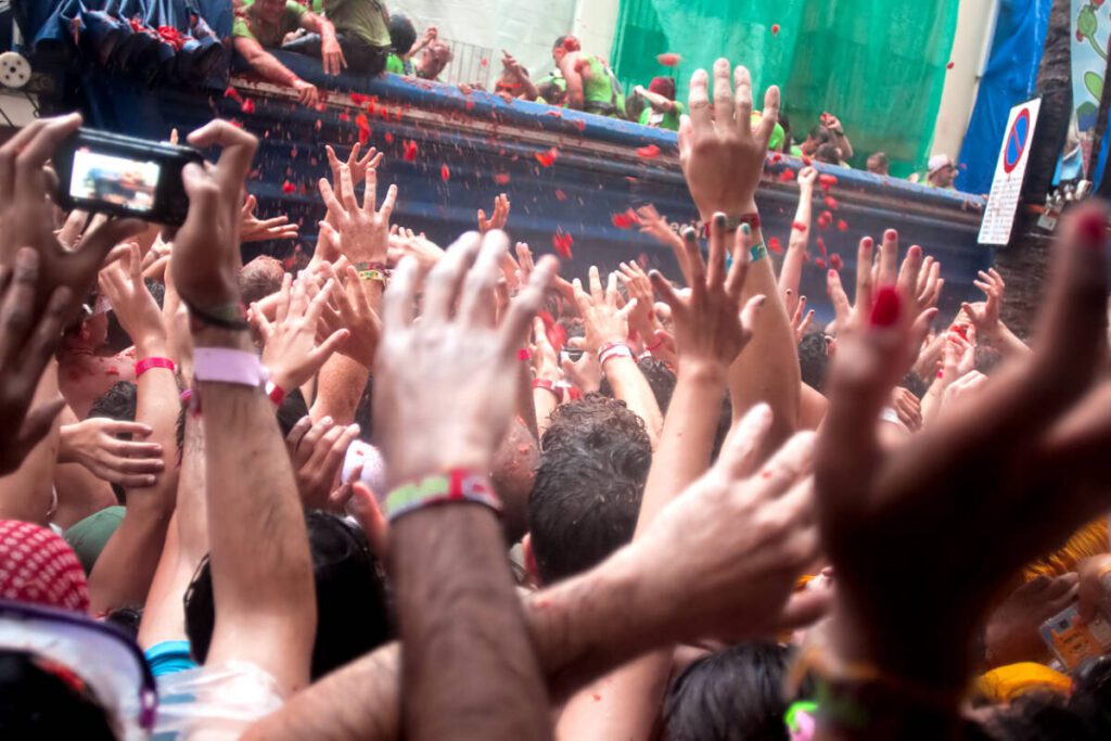 Bunol, Spain - August 28, 2013: With a truck throw tomatoes into crowd on Tomatina festival in Bunol. in Spain